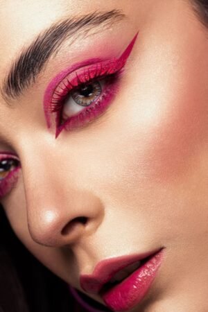 pexels photo 27521010 27521010 Close-up of a woman's face highlighting bold pink eyeliner and makeup in an artistic portrait.