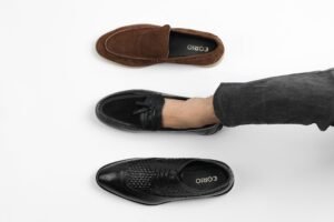 pexels photo 31935098 31935098 Top view of three men's leather shoes in different styles on white background.