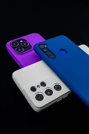 pexels photo 32912373 32912373 Three colorful smartphones with various camera designs on a dark surface.