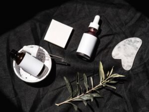 pexels photo 8102132 8102132 Flat lay of skincare bottles and leaves on black fabric. Perfect for beauty and wellness themes.